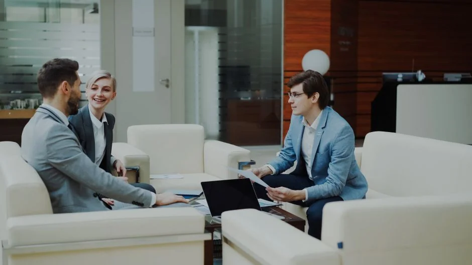 Two colleagues work together on a marketing strategy at a whiteboard, with a focus on user-generated content.